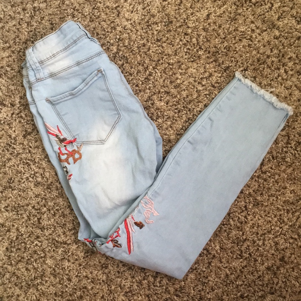 Ripped light blue jeans with frayed hem